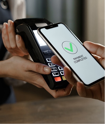 Close up of hand paying via tap.